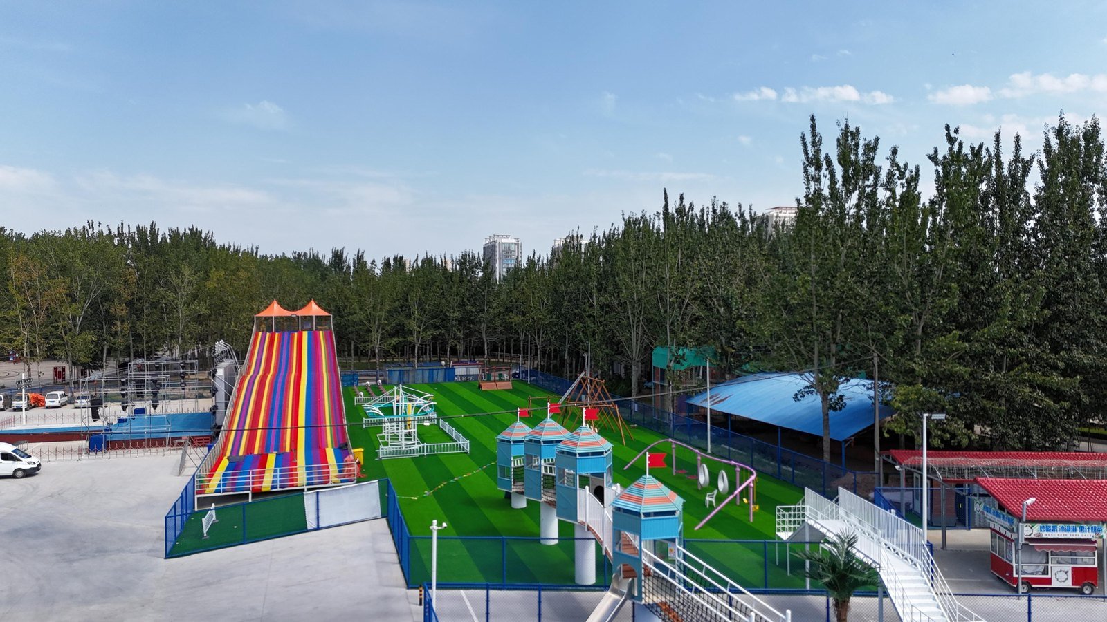 Large outdoor family entertainment area with slides and play structures
