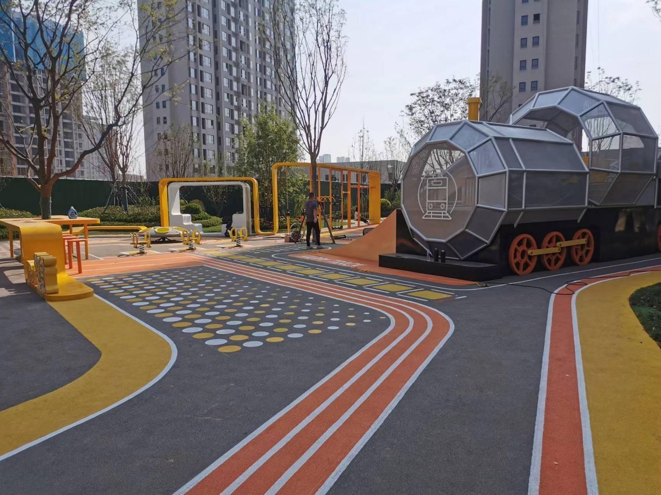 Installed outdoor play zone with running paths and themed structures